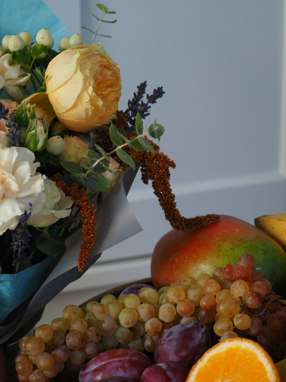 a bunch of fruit and flowers on a table