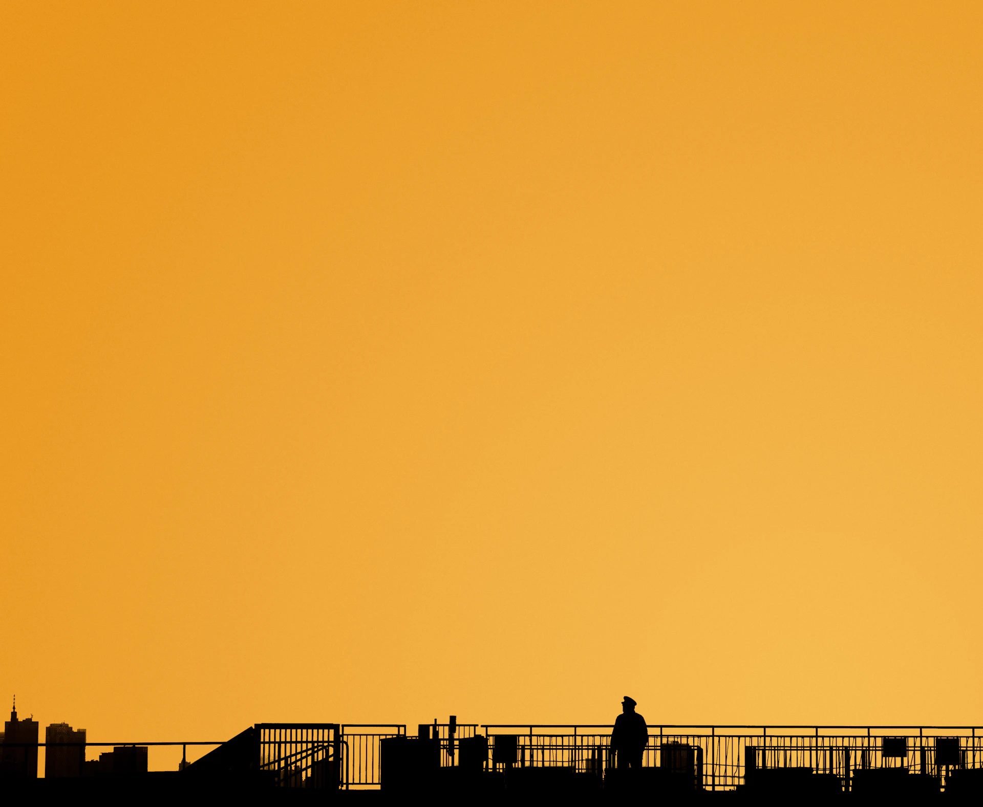 a person walking across a bridge with an airplane in the background