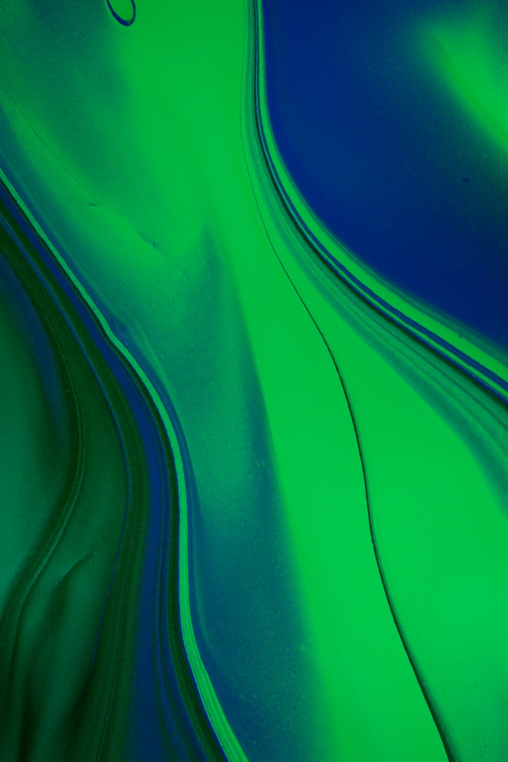 a green and blue background with wavy lines
