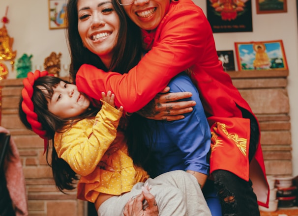 a man and a woman holding a child in their arms