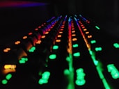 a close up of a sound board with many lights on it