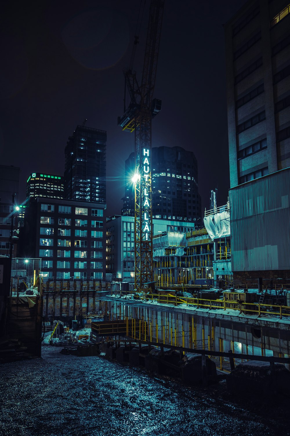 a large crane in a city at night