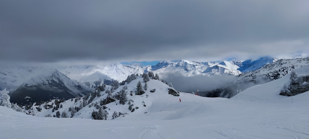 a person on skis standing on top of a snow covered mountain