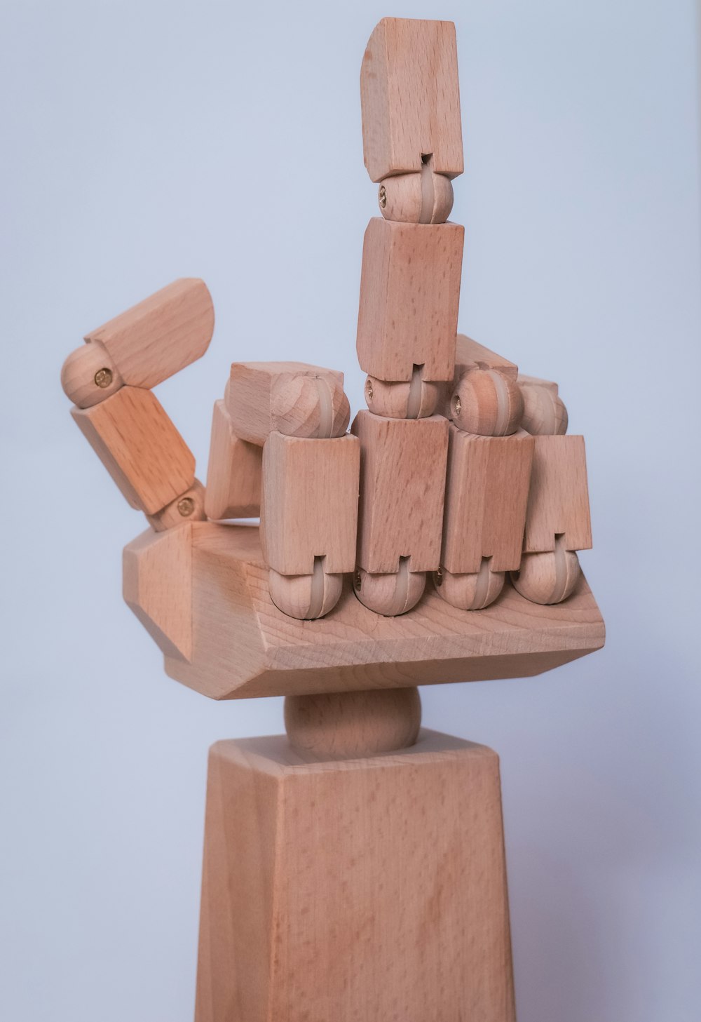 a wooden sculpture of a stack of wooden blocks