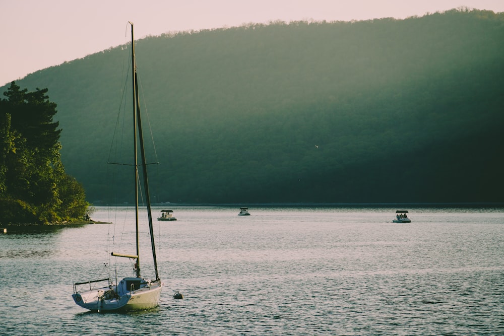 a small sailboat in the middle of a large body of water