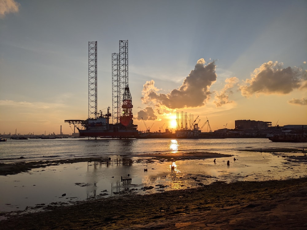 the sun is setting over a large body of water