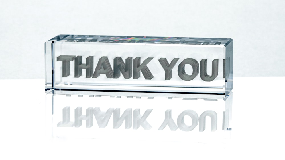 a glass block with the words thank you on it