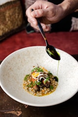 a person is spooning food out of a bowl