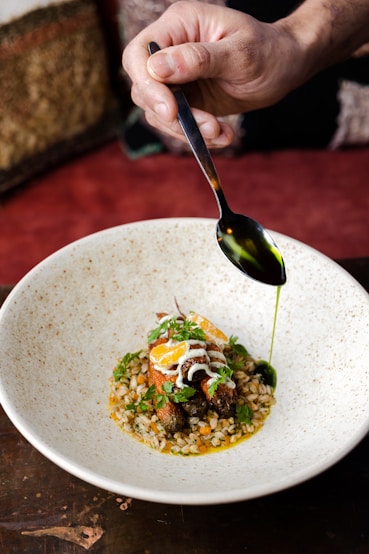 a person is spooning food out of a bowl
