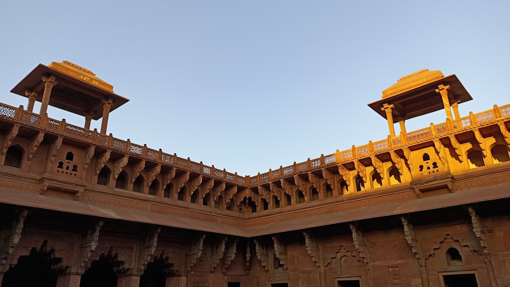 a large building with two towers and a sky background