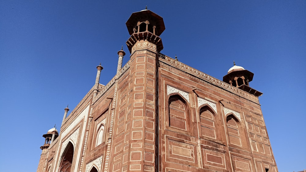 a tall brick building with a clock on the top of it