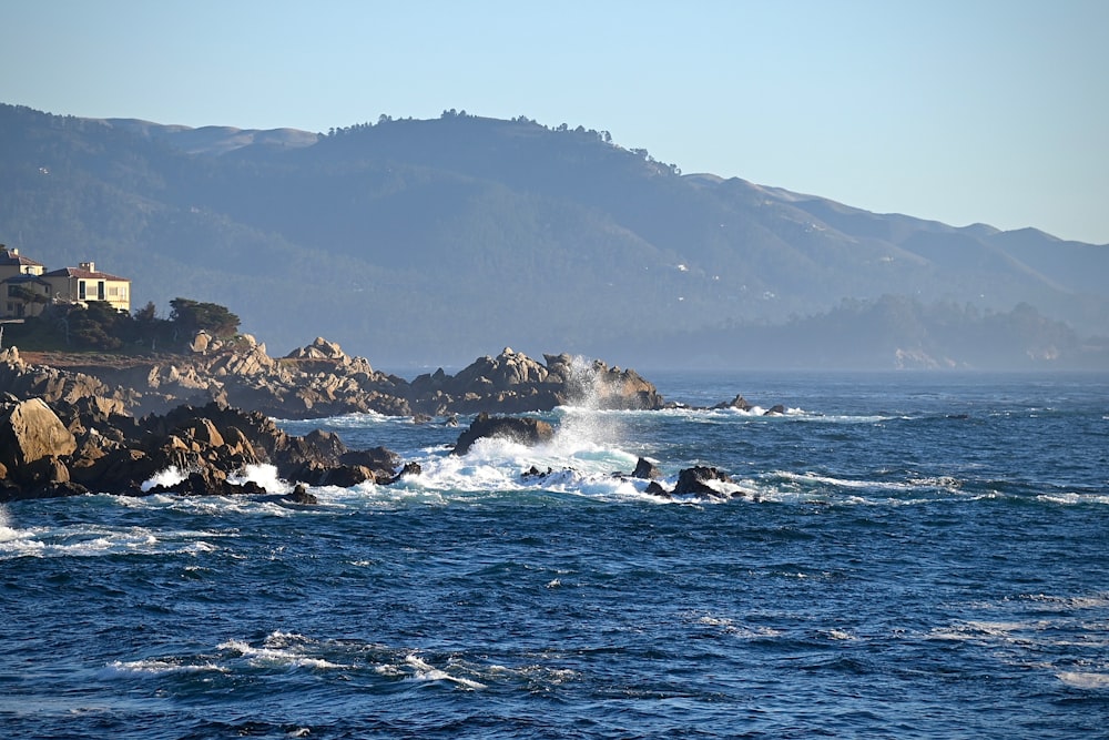 a body of water surrounded by rocks and houses