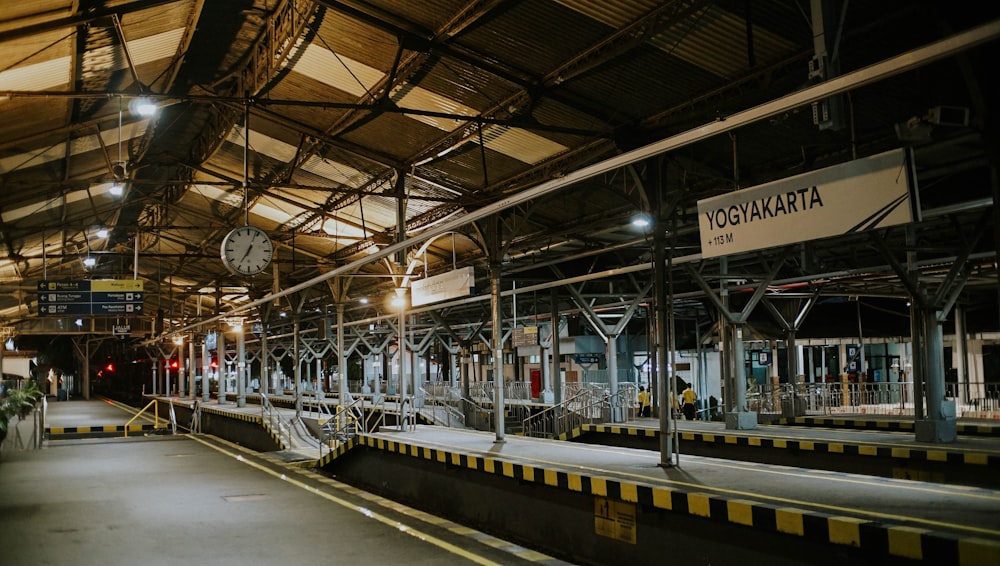 a train station with a clock on the wall