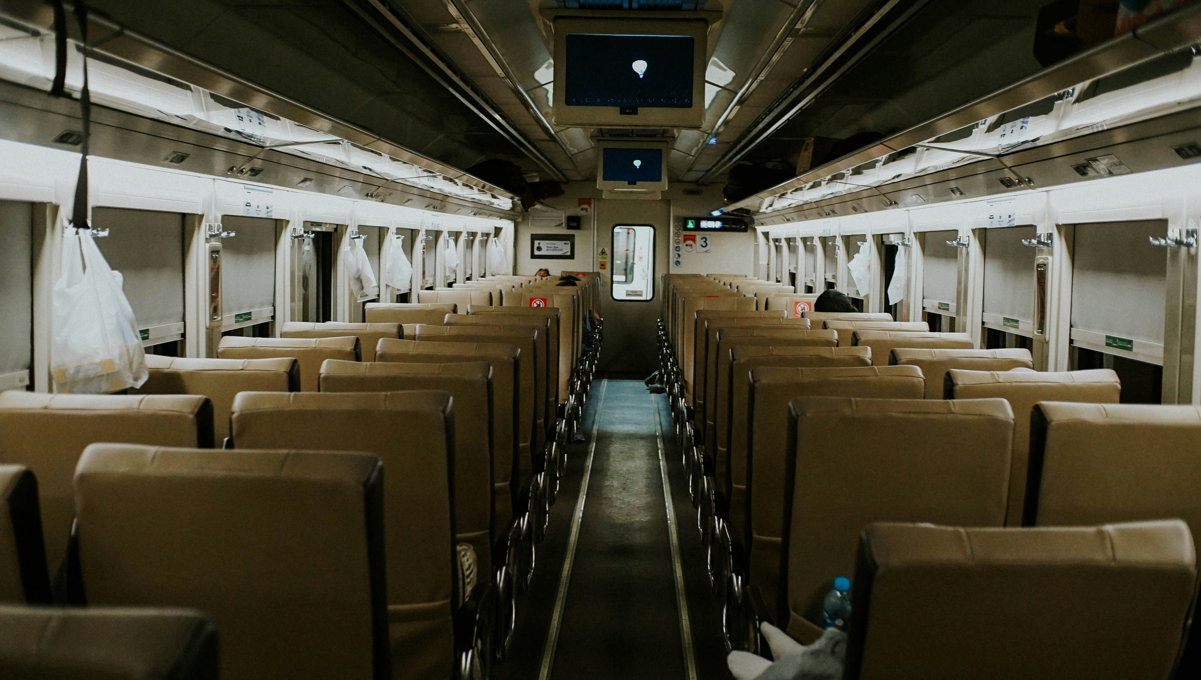 a train car filled with lots of empty seats, 