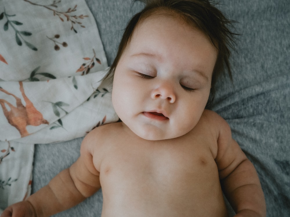 a baby lying on a bed