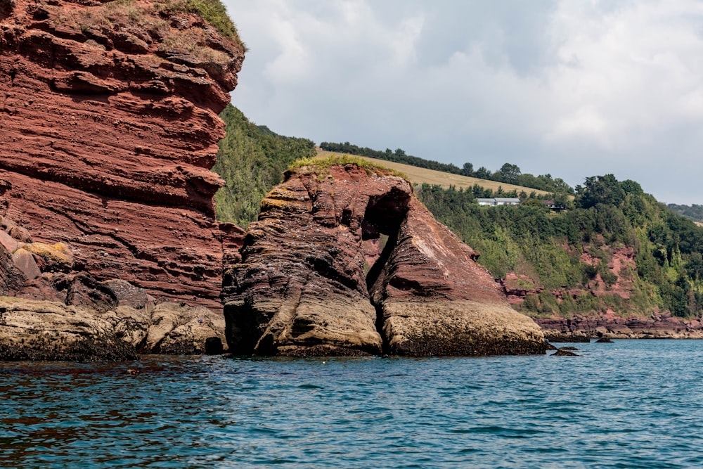 a rock formation in the middle of a body of water