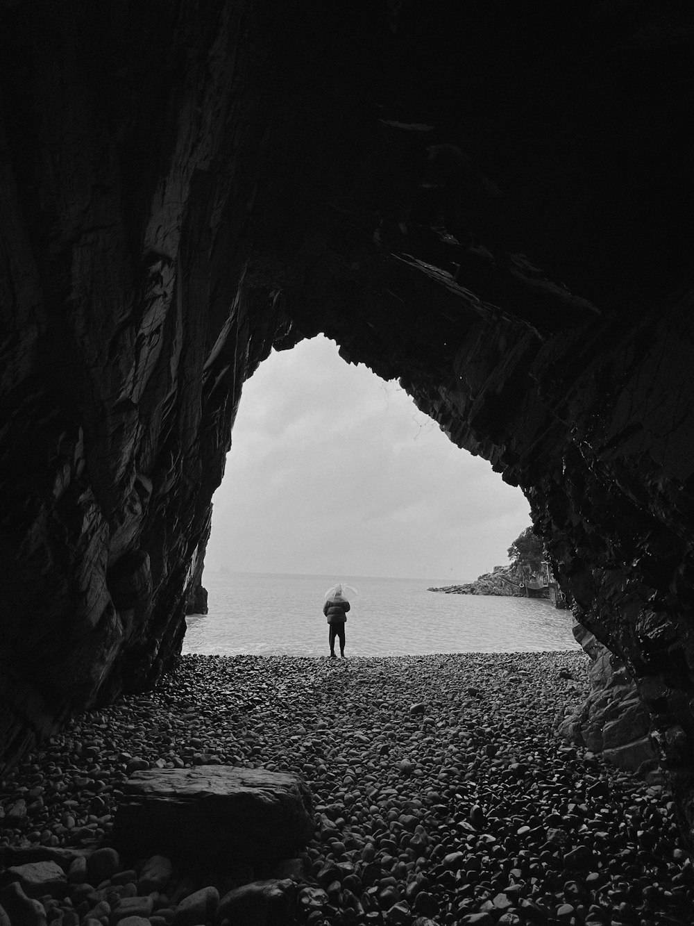 a man standing next to a body of water