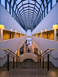 a very long building with some people walking up and down the stairs
