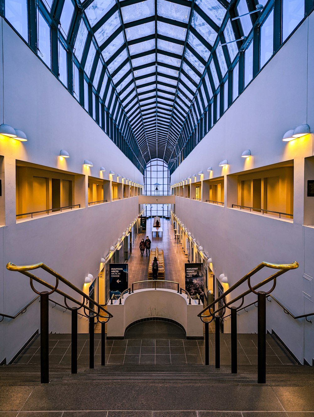 a very long building with some people walking up and down the stairs