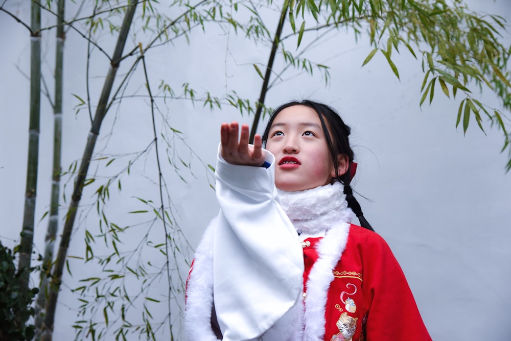 a woman wearing a red and white outfit and a white scarf