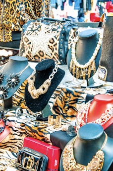 a table topped with lots of different types of purses