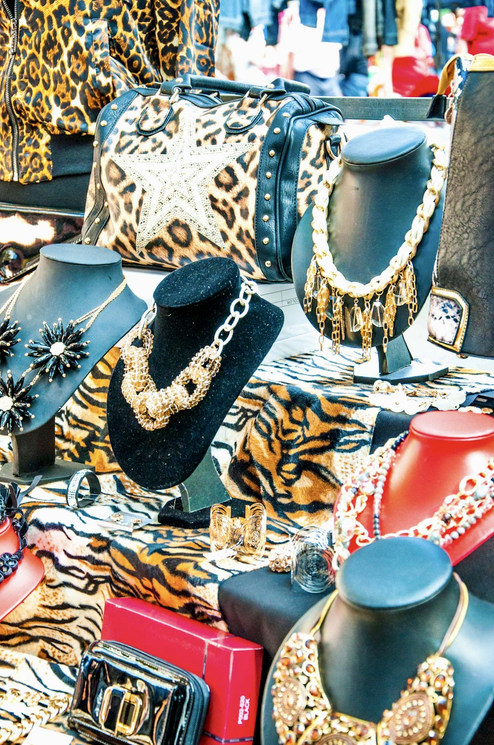 a table topped with lots of different types of purses