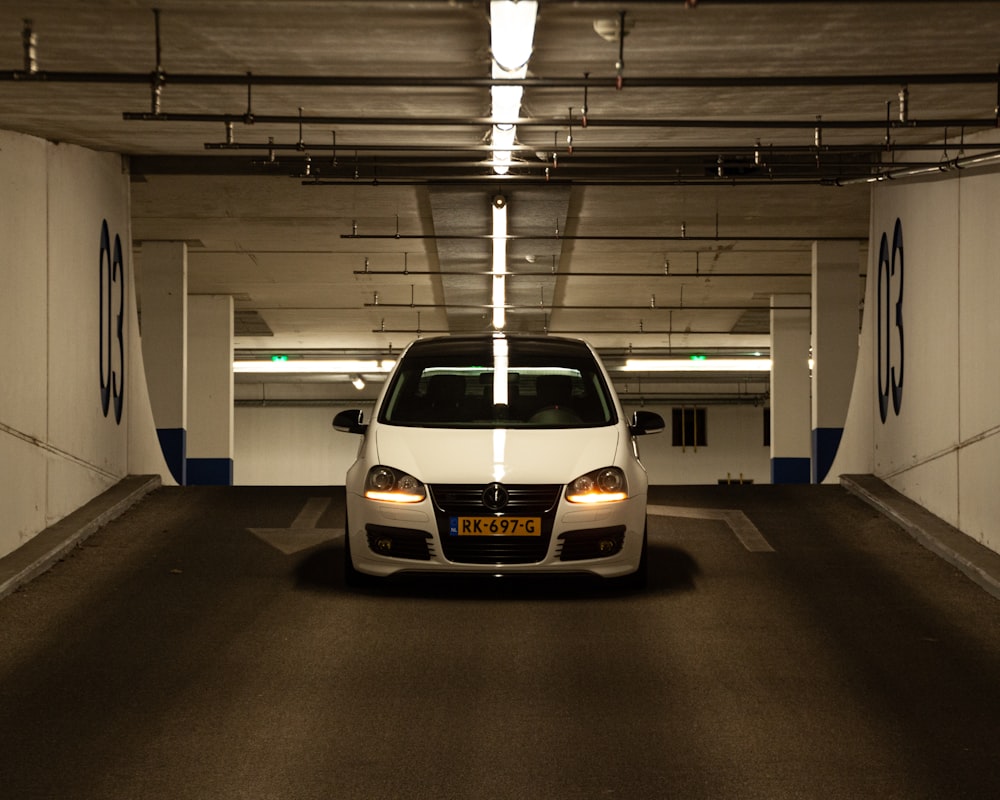 a white car parked in a parking garage