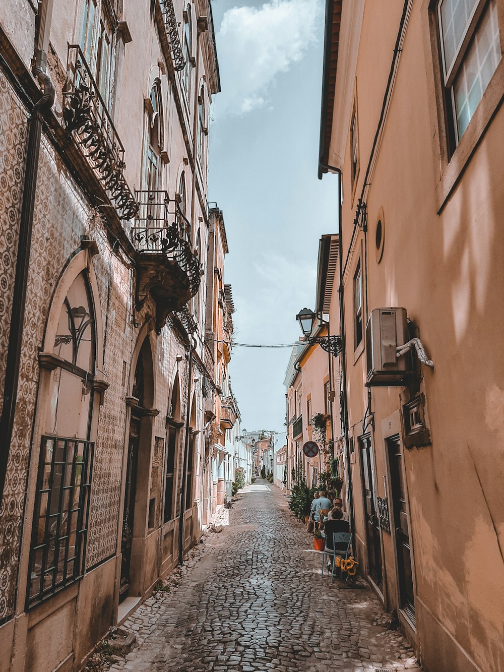 a narrow cobblestone street in a european city