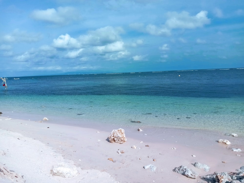 a sandy beach with a boat in the distance