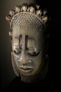 a wooden mask with spikes on it's head