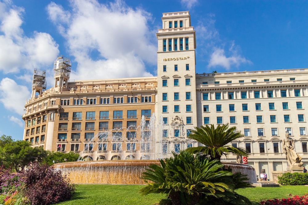 a large building with a fountain in front of it