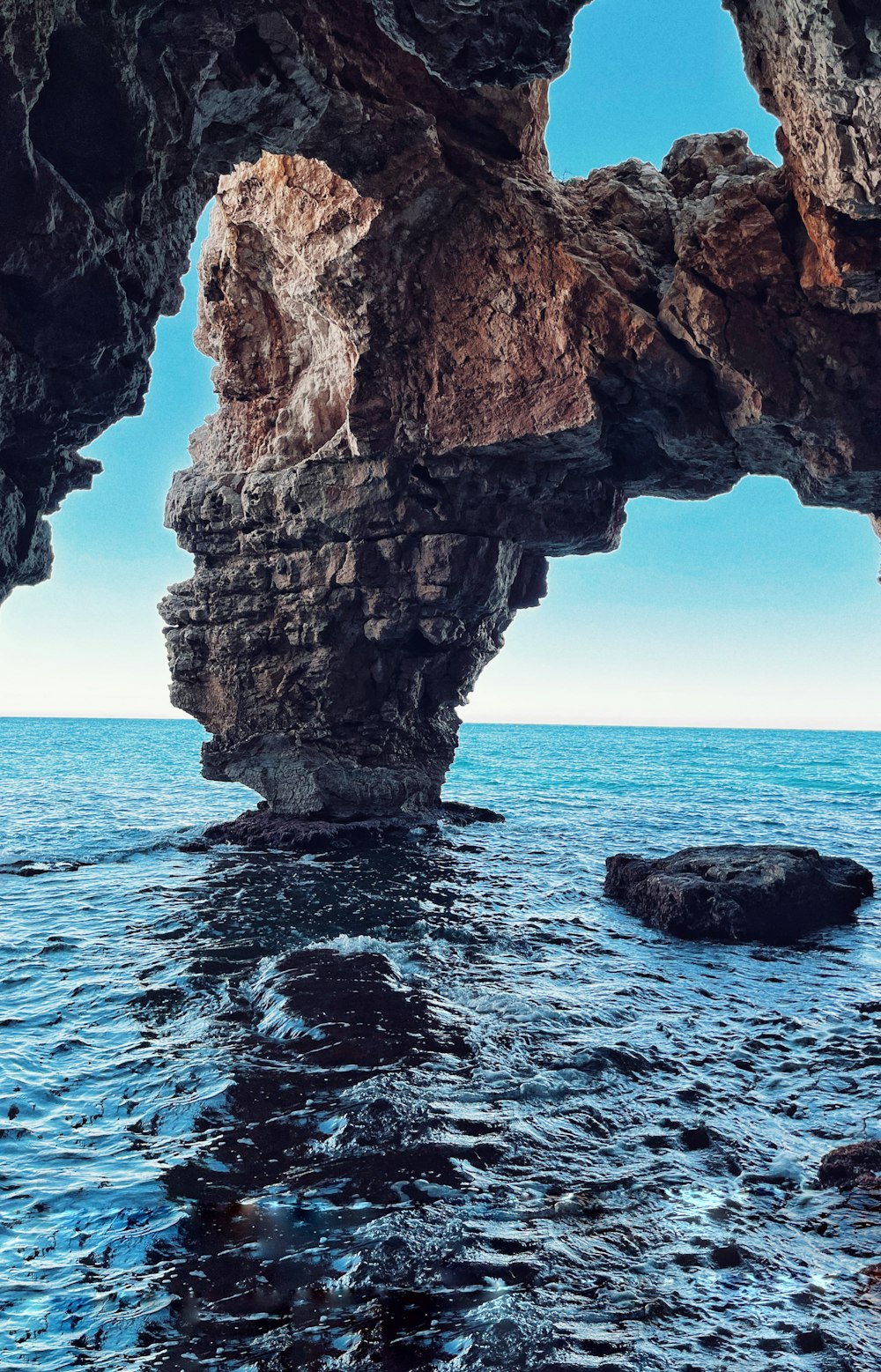 a view of the ocean from inside a cave