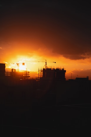 A vibrant sunset over a construction site.