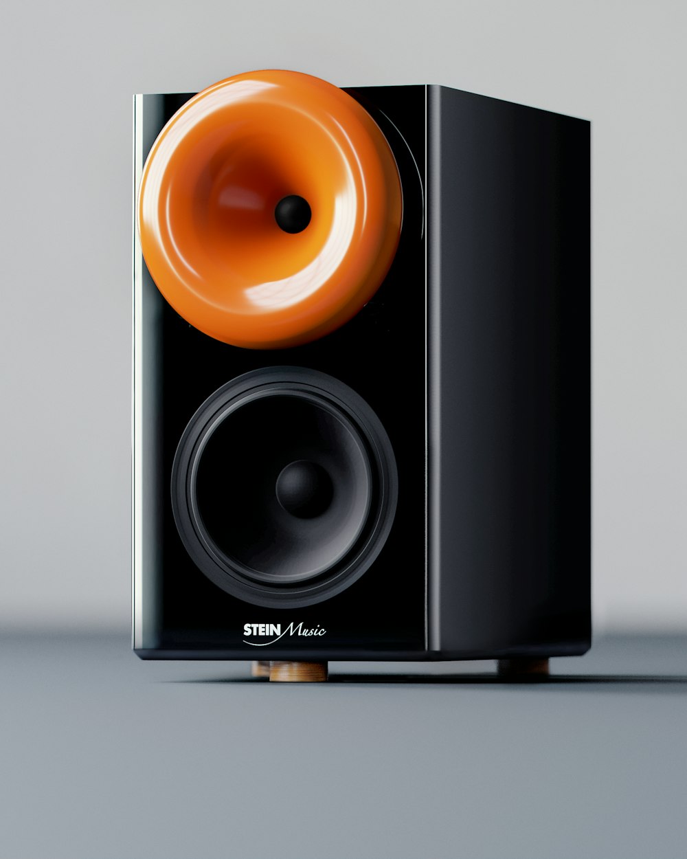 a black speaker with an orange knob on top of it