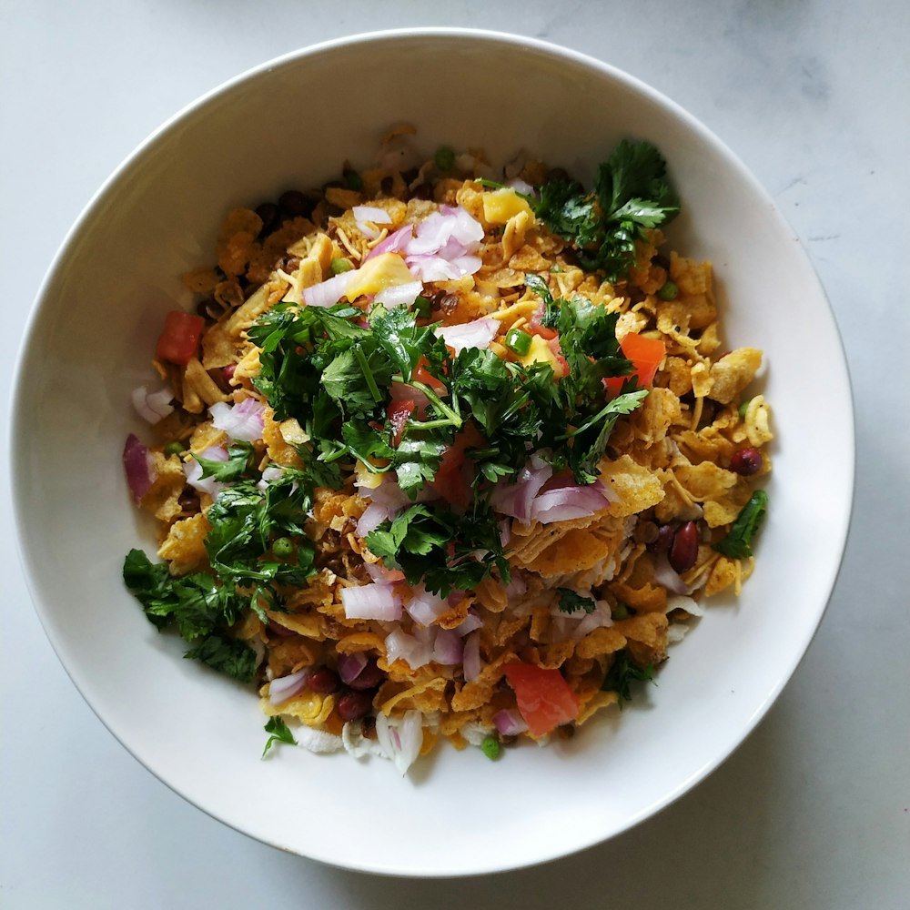 a white bowl filled with food on top of a table