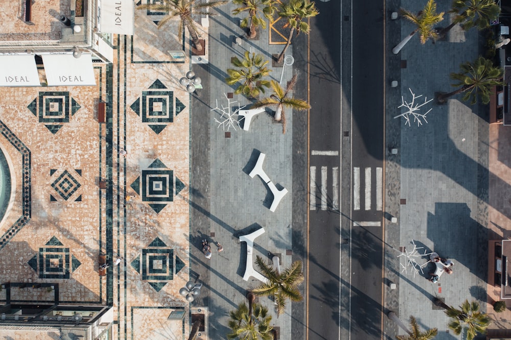 an aerial view of a clock tower with palm trees