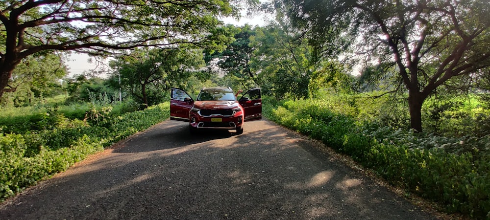 a red car parked on the side of a road