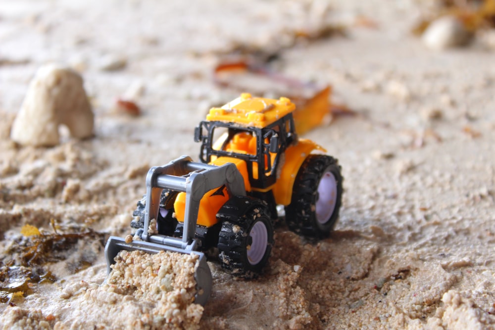 a toy truck is sitting in the sand