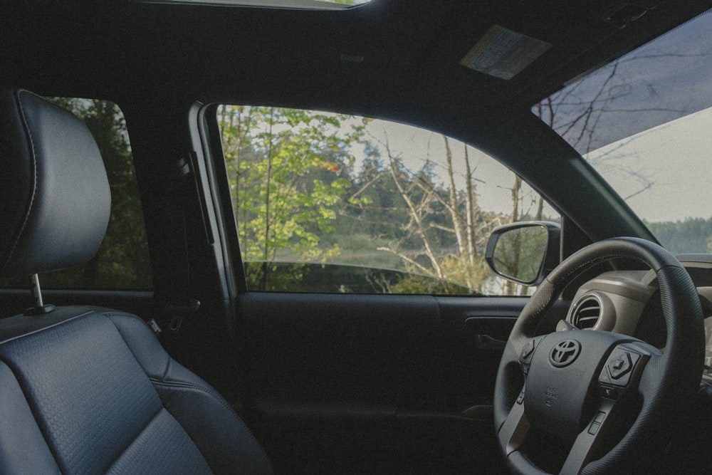 the interior of a car with a steering wheel and dashboard