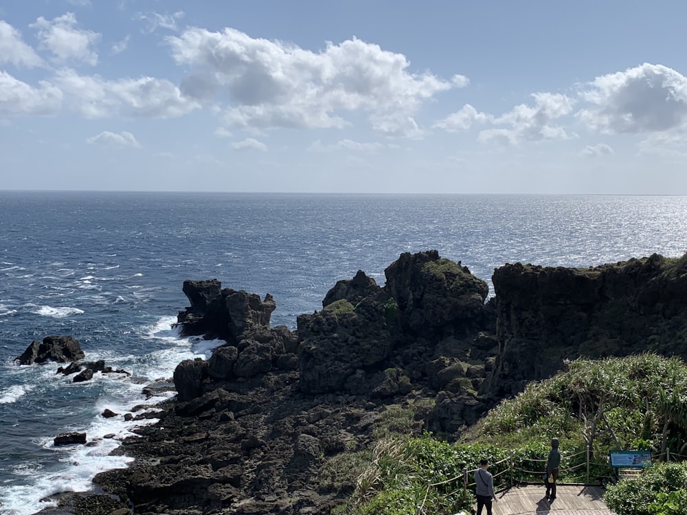 a couple of people that are standing on some rocks