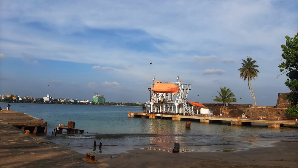 a boat docked at a pier on a body of water