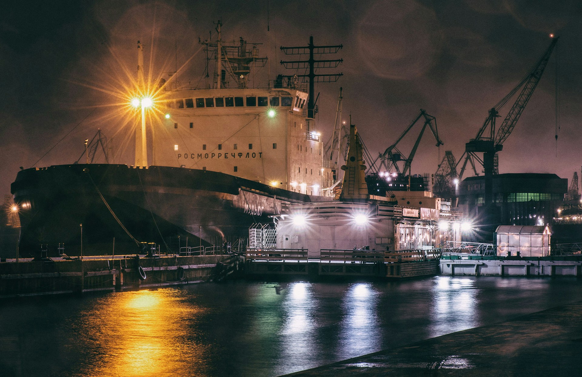 a large ship in a harbor at night