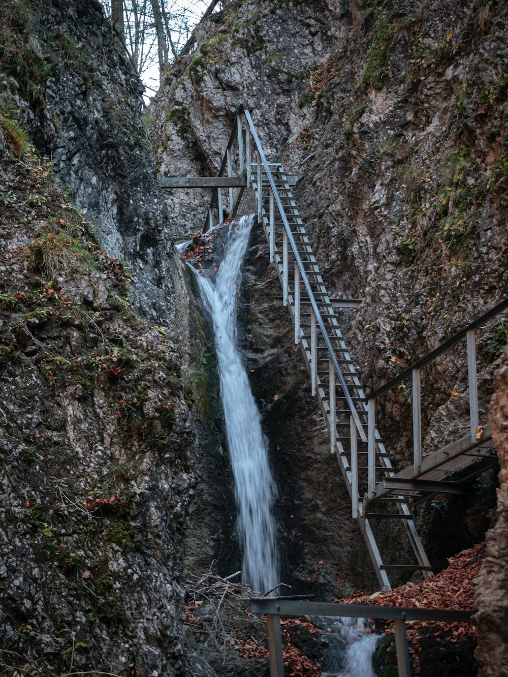 a waterfall is coming down the side of a mountain