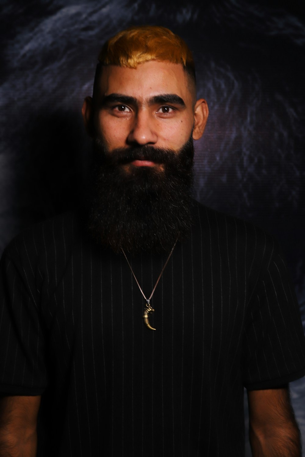 a man with a beard wearing a black shirt