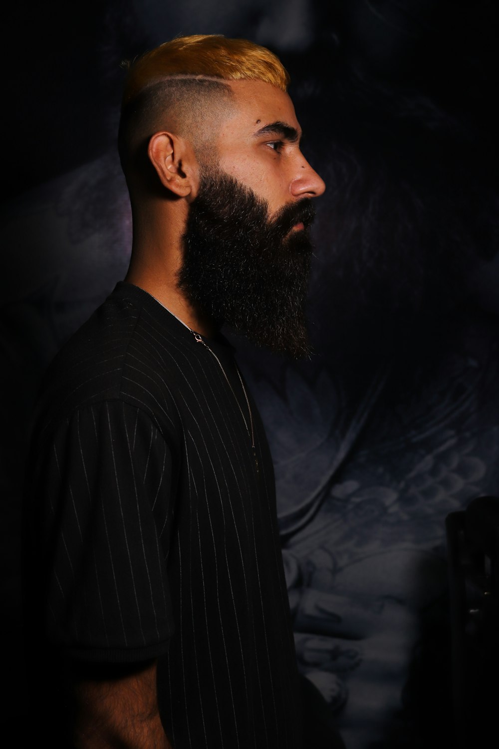 a man with a beard and a shaved head
