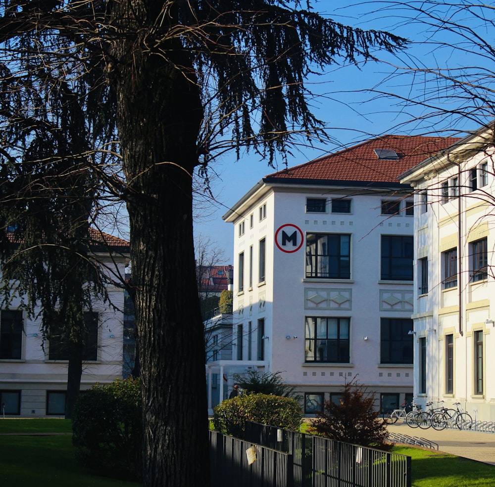 a large white building with a red and white sign on it