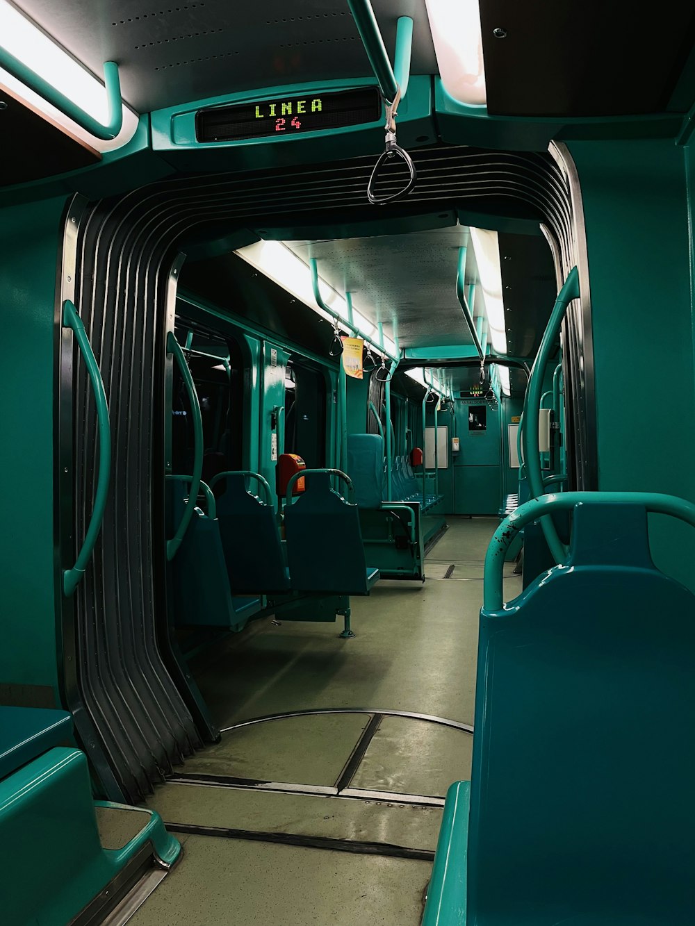 a subway car with green seats and a light on