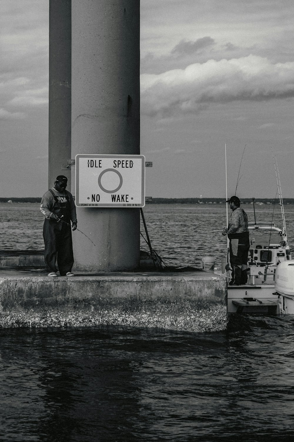 a couple of men standing next to a boat