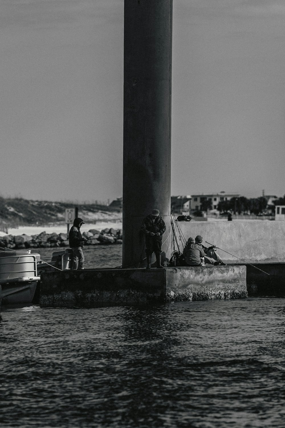 a black and white photo of people on a dock