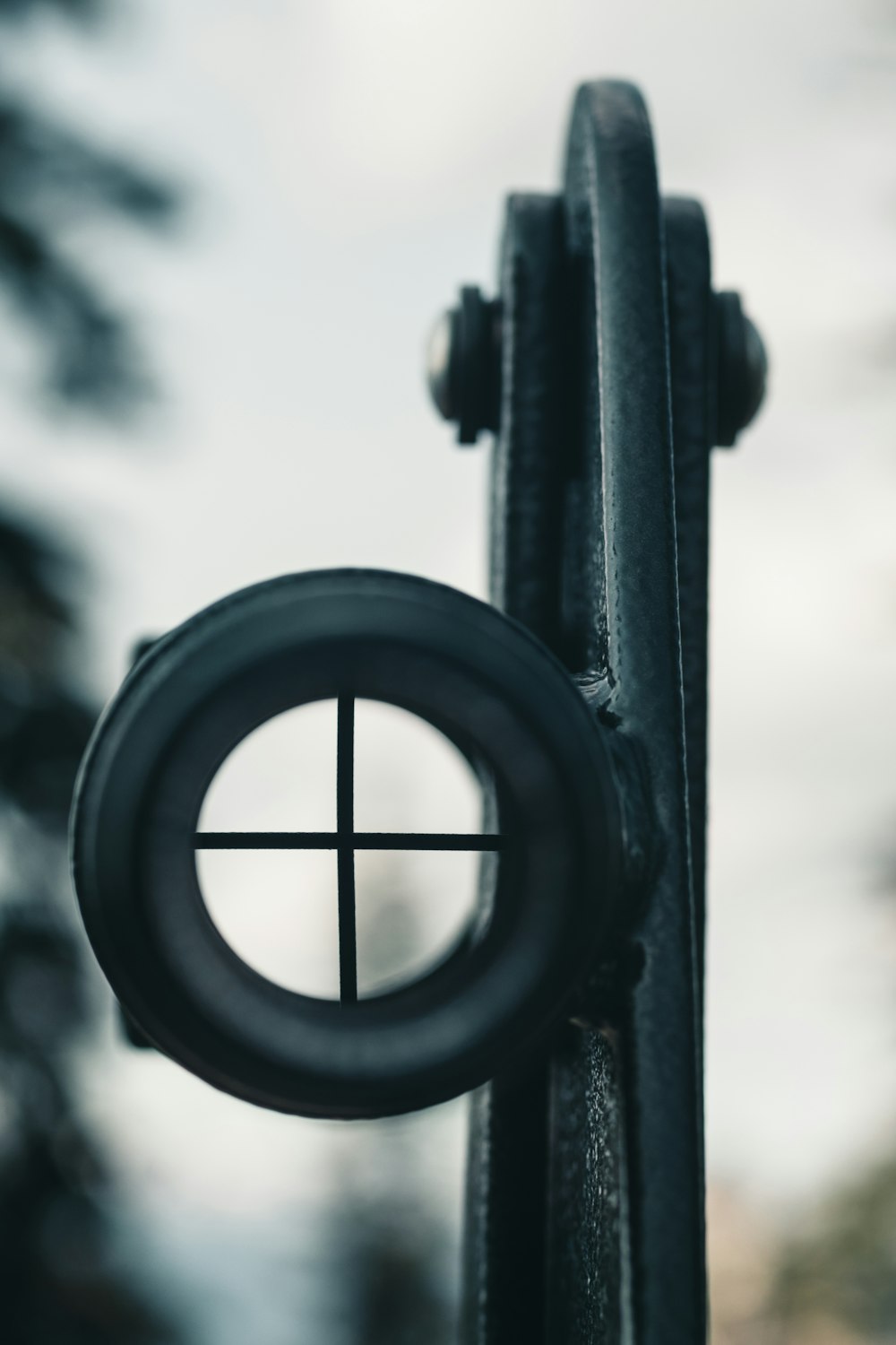 a close up of a metal object with a cross on it